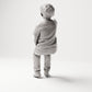 Sitzende Figur: Junge in T-Shirt & Hose mit ausgestrecktem Zeigefinger (B006) - Rueckansicht