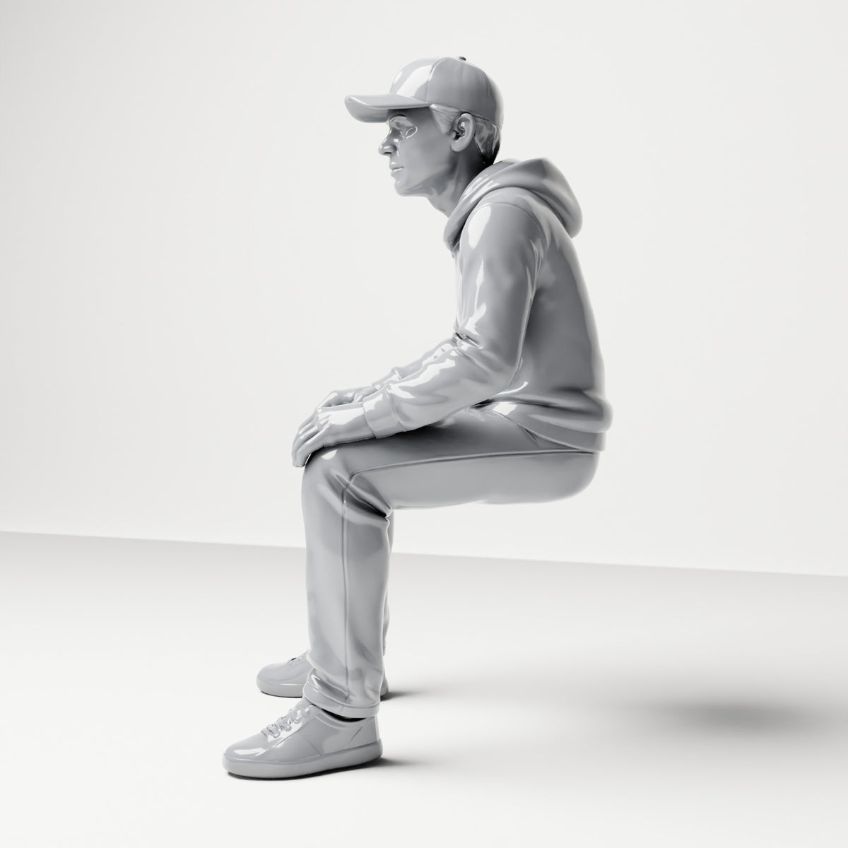 Diorama modelbouw productfoto 1: Zittende figuur: man met pet & hoodie (B070)