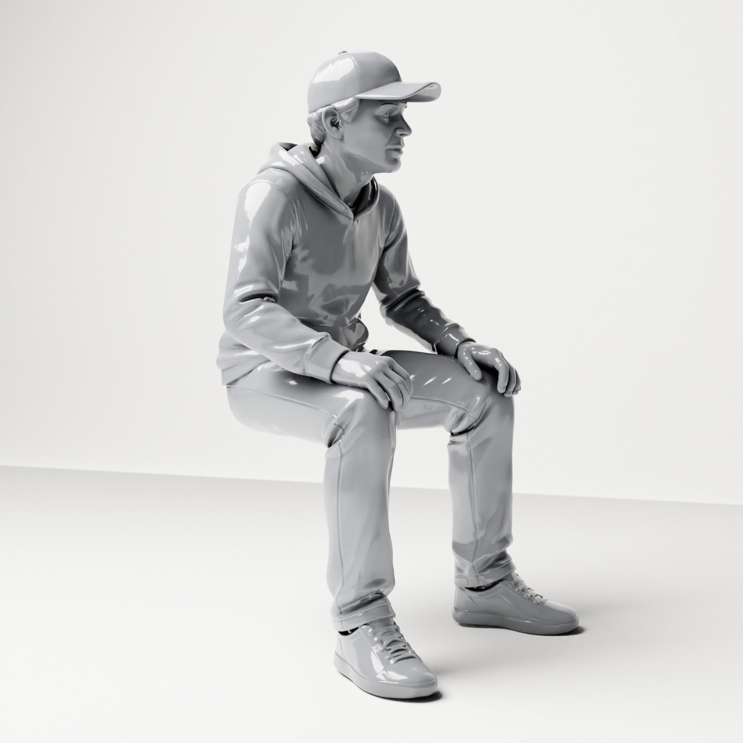 Diorama modelbouw productfoto 3: Zittende figuur: man met pet & hoodie (B070)